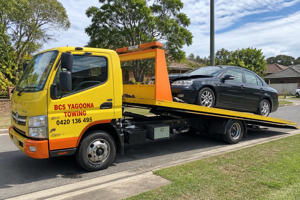 Car being loaded onto a BCS Yagoona Towing flatbed tow truck