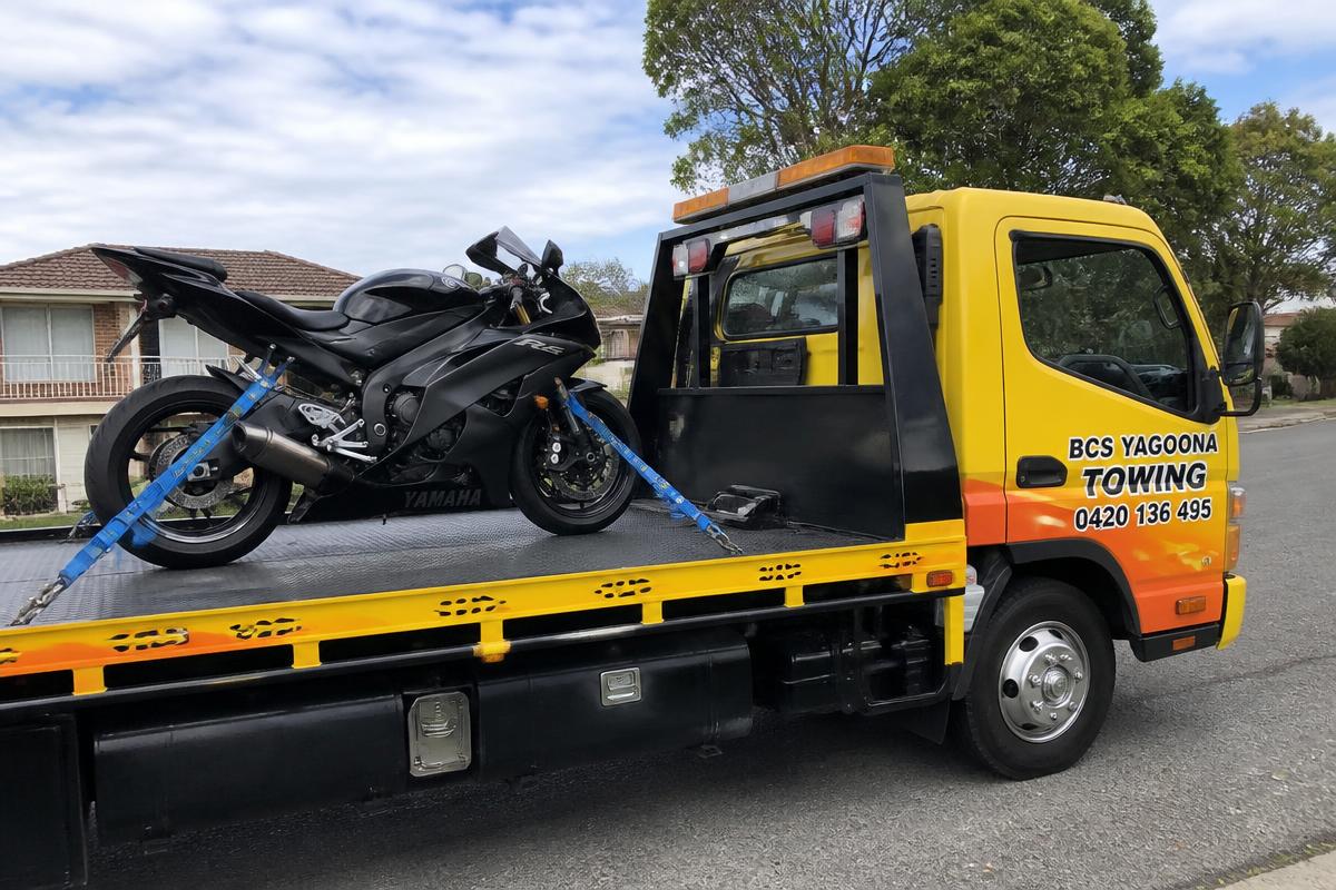 Motorbike strapped to a BCS Yagoona Towing flatbed tow truck